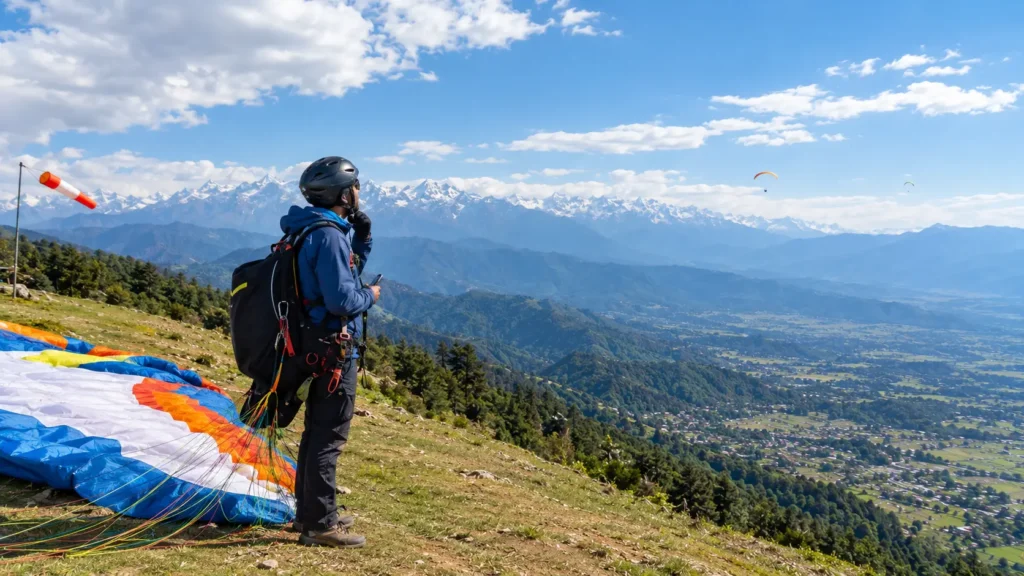 Paragliding pilot checking weather conditions before a flight at Bir Billing